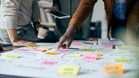 people working on new business project and analyzing mind map on paperboard