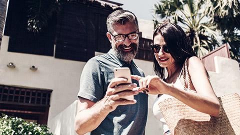 a couple looking at directions help on their phone