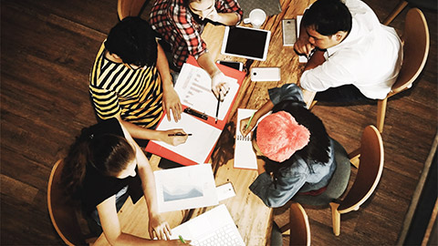 a group meeting discussing market/client feedback