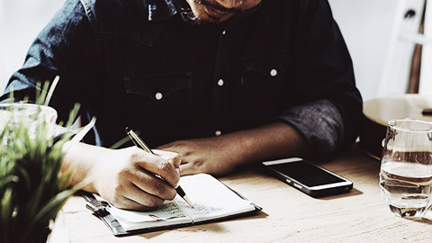 A person ticking off items in a checklist