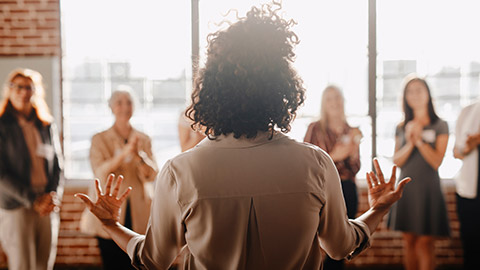 African american female empowering other colleagues in workplace