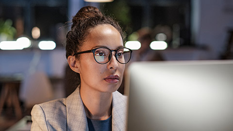 Serious young multiethnic business lady in eyeglasses