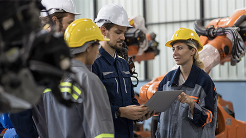 Male and female engineer working in autonomous robotics warehouse storage