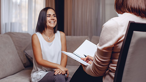 a happy patient sitting at a psychologist's appointment