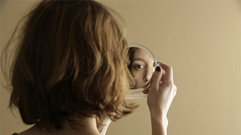 Mirror reflection of a woman's face