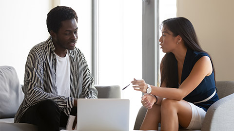 Asian ethnicity female bank counsellor consulting american man