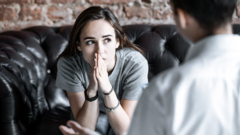 Young girl talking to a therapist