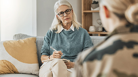 psychologist talking to a patient about mental health in an office.