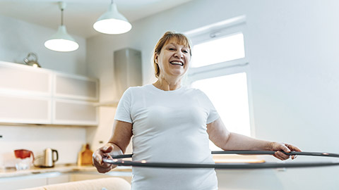 Exercising with hula hoop inside home