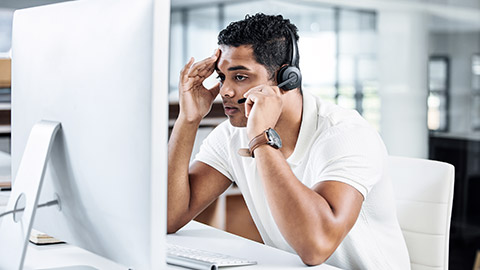 Man on call infront of the computer