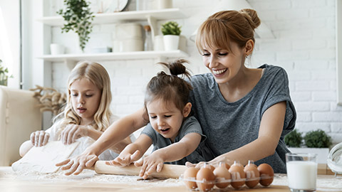 Happy mother baking with 2 kids