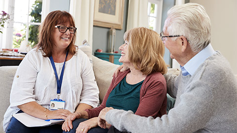 Female Support Worker Visits Senior Couple At Home