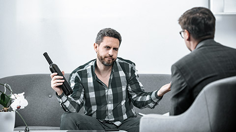 alcoholic man talking with psychologist