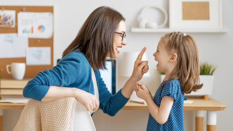 mother bonding with child while working