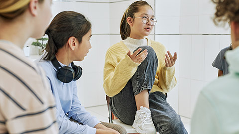 teenage girl sharing feelings in support group circle for children