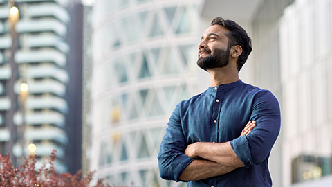 man standing in modern big city looking and dreaming of future success