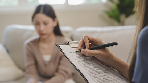 patient counseling mental with doctor woman taking notes at clinic