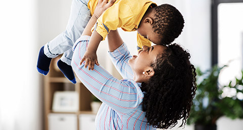 A person holding up 2 year old son