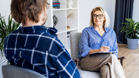 psychologist having session with male patient at mental health clinic