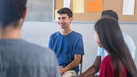 Happy Teenager student talking to classmates - Support Group discussion at School