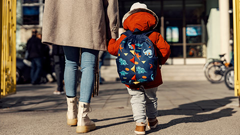 A mother dropping her child off at childcare