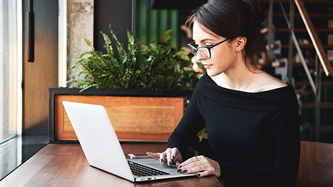 A person using a laptop to access resource materials