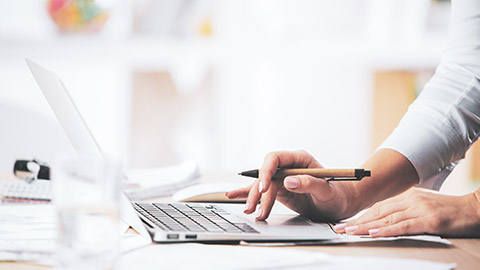 A close view of a supervisor reading complaints on an online forum