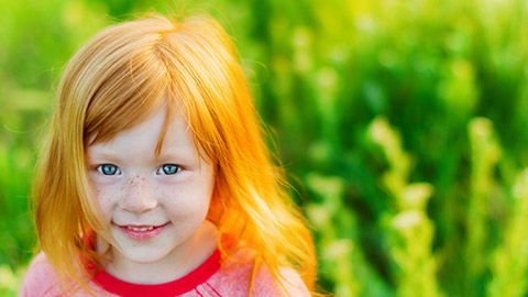 A young child smiling at the camera