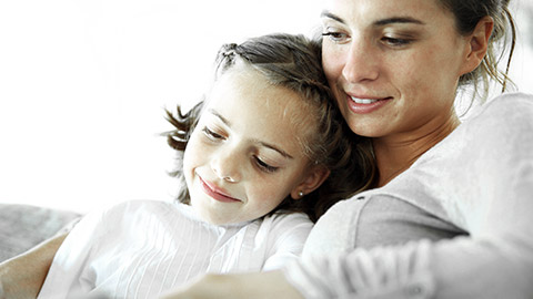 Mom reading a book to a child