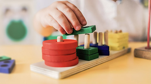 A close view of a child playing with blocks