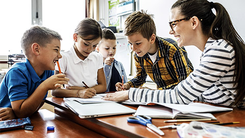 teacher helping her students