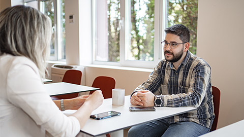 Man Sitting at Table With Woman