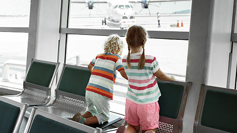 Kids looking at airplane at the airport