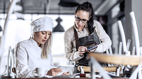 Chef and staff calculating the costs