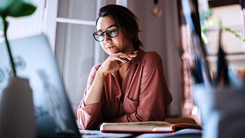 Young woman with computer brainstorming