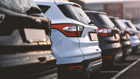 A line of cars in a parking lot