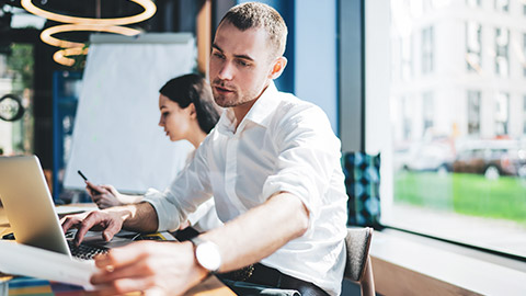 An accountant working on client financial information in a modern office space