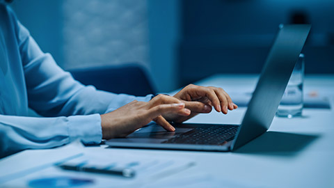 A close view of a person typing on a laptop