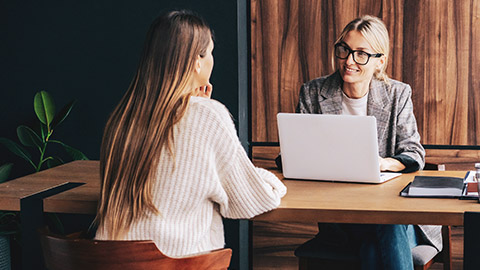 2 people talking in an office