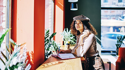 A designer doing further studying in a cafe