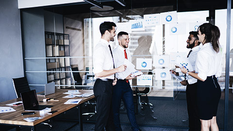 Four employees on a stand up informal meeting