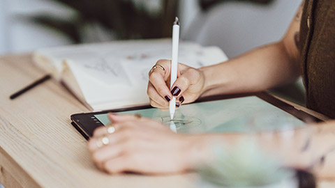 A close view of a designer working on a tablet device