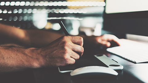 A close view of a designer working on a computer