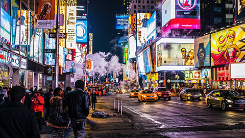 A wide shot of Times Square at night