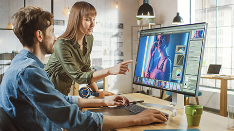 Female Art Director Consults Designer Colleague, They Work on a Portrait in Photo Editing Software.