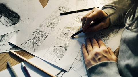 a designer drawing a story board