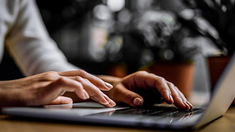 A person typing on a keyboard