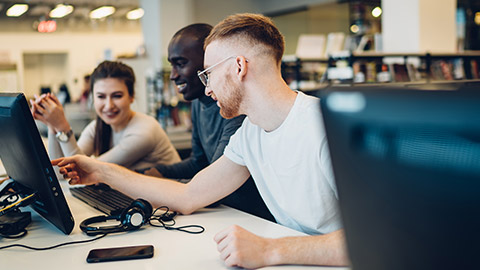 A group of designers looking at a presentation on a computer screen