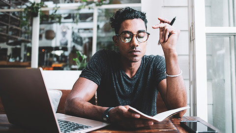 A person reading at a table in a relaxed aatmosphere