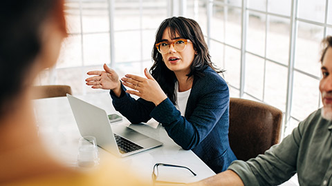 Professional woman talking to her team in an office meeting